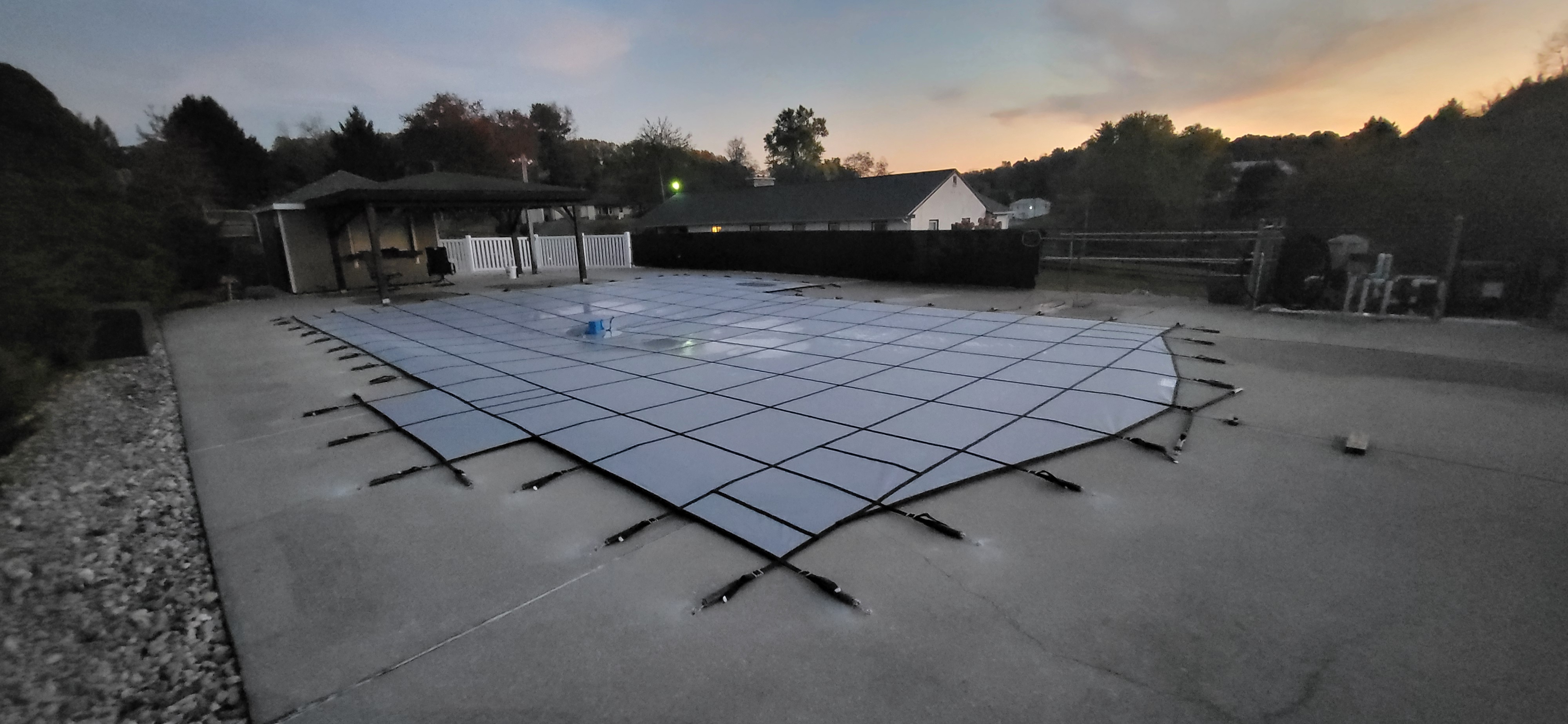 Safety cover installation at sunset